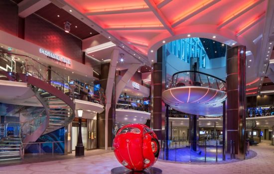 SY, Symphony of the Seas, Rising Tide Bar, wide shot of Royal Promenade - Deck 5 Midship Center, with Beetle Sphere red car sculpture center, Focus and Picture This Portrait Studio above, artwork, art, sculpture,